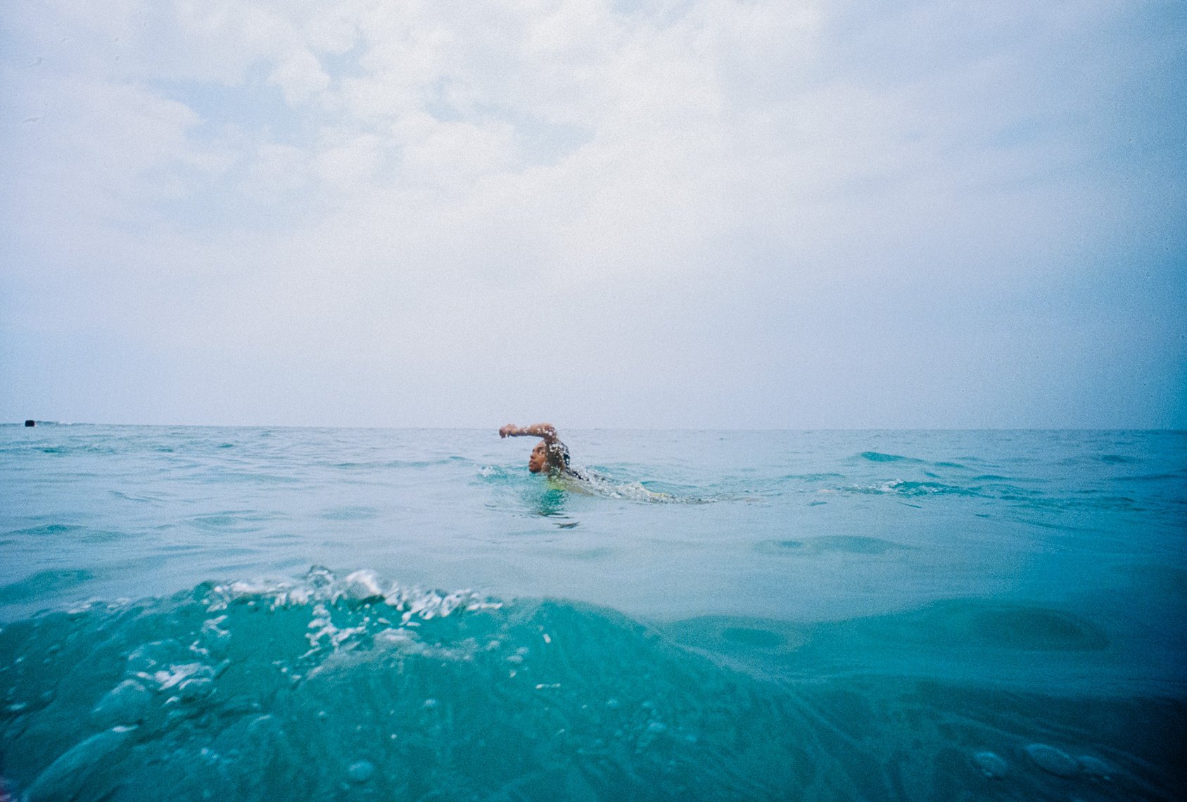 Woman swimming in blue water 